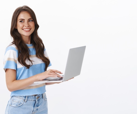charming-young-woman-working-freelance-remote-from-office-hold-laptop-typing-university-essay-turn-left-smiling-copy-space-joyful-browsing-web-using-computer (1)