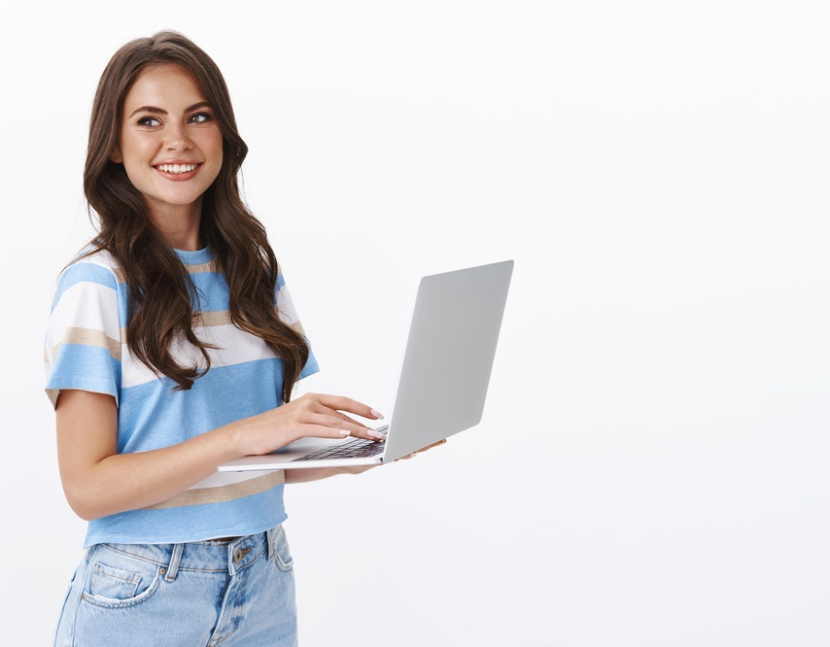 charming-young-woman-working-freelance-remote-from-office-hold-laptop-typing-university-essay-turn-left-smiling-copy-space-joyful-browsing-web-using-computer (1)